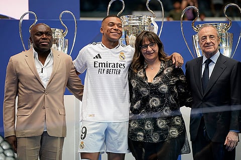 Kylian Mbappe poses with his parents and Florentino Perez